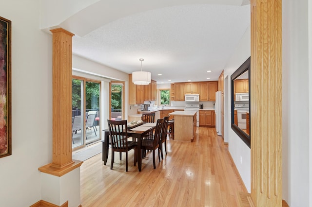 9534 Kirkwood Way N, Maple Grove, MN 55369 - dining room featuring decorative columns, light wood-style flooring, and recessed lighting