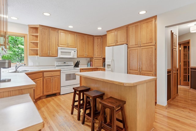 9534 Kirkwood Way N, Maple Grove, MN 55369 - kitchen with white appliances, light wood finished floors, a center island, light countertops, and recessed lighting