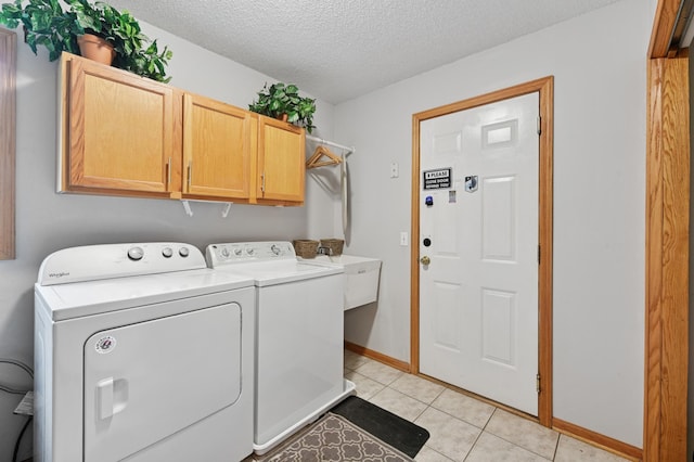 9534 Kirkwood Way N, Maple Grove, MN 55369 - laundry area with separate washer and dryer, cabinet space, a textured ceiling, and light tile patterned floors