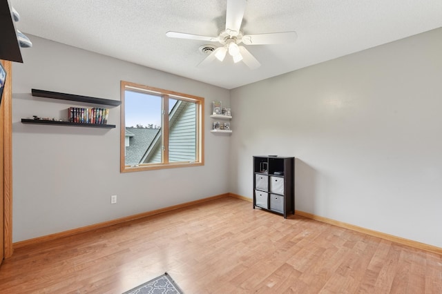 9534 Kirkwood Way N, Maple Grove, MN 55369 - empty room with wood finished floors, a ceiling fan, and a textured ceiling