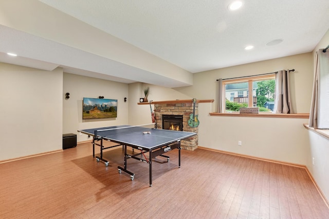 9534 Kirkwood Way N, Maple Grove, MN 55369 - recreation room featuring wood finished floors, a stone fireplace, and recessed lighting