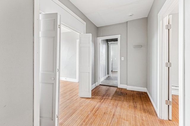 65 George St E, Saint Paul, MN 55107 - hall with light wood-style flooring and a baseboard heating unit