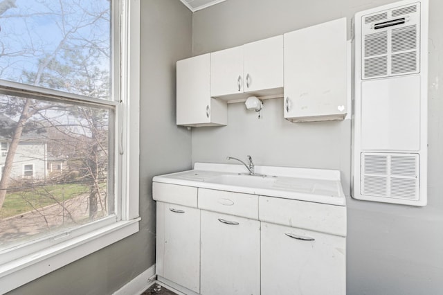 65 George St E, Saint Paul, MN 55107 - kitchen with light countertops, a heating unit, and white cabinetry