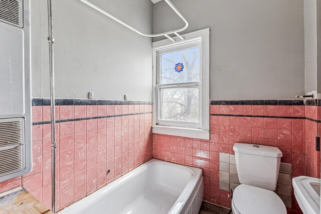 65 George St E, Saint Paul, MN 55107 - full bathroom with tile walls, a bath, wainscoting, and a heating unit