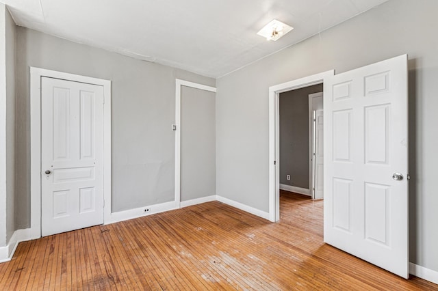 65 George St E, Saint Paul, MN 55107 - unfurnished bedroom with baseboards and light wood finished floors