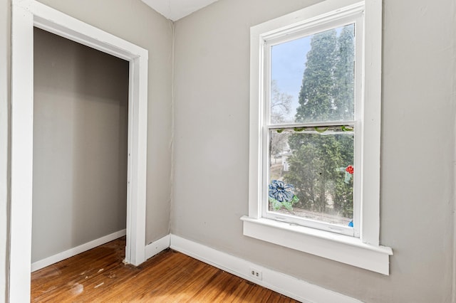 65 George St E, Saint Paul, MN 55107 - unfurnished bedroom featuring multiple windows and wood finished floors