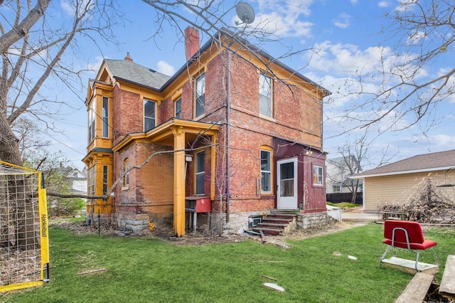 65 George St E, Saint Paul, MN 55107 - rear view of house with brick siding, a chimney, a yard, and entry steps