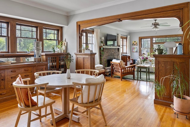 5000 Newton Ave S, Minneapolis, MN 55419 - dining room featuring light wood-style floors, a ceiling fan, a fireplace, and ornamental molding