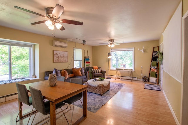 724 10th St NW, Bemidji, MN 56601 - living room featuring a baseboard heating unit, a wall mounted AC, healthy amount of natural light, and light wood-style floors