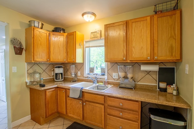 724 10th St NW, Bemidji, MN 56601 - kitchen with light tile patterned floors, backsplash, light countertops, and brown cabinetry