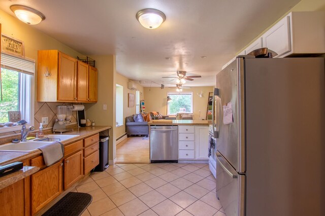724 10th St NW, Bemidji, MN 56601 - kitchen with stainless steel appliances, light tile patterned flooring, open floor plan, light countertops, and ceiling fan