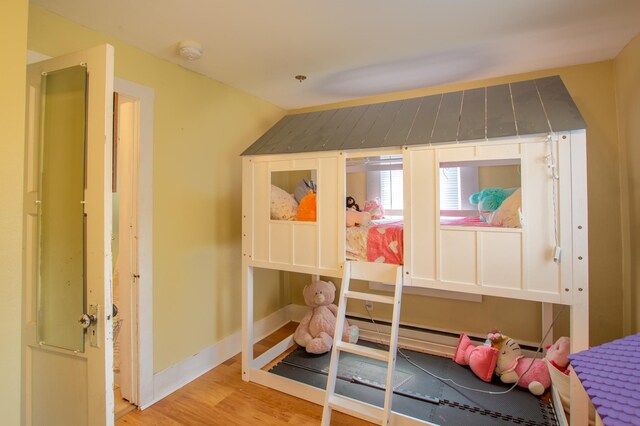 724 10th St NW, Bemidji, MN 56601 - bedroom featuring light wood-style floors and a baseboard heating unit