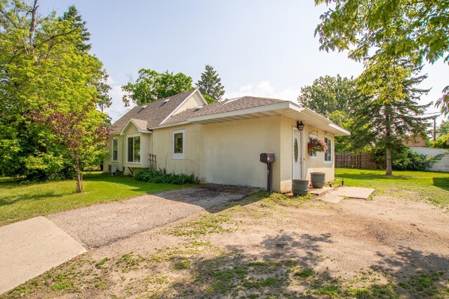 724 10th St NW, Bemidji, MN 56601 - view of property exterior with stucco siding and a shingled roof