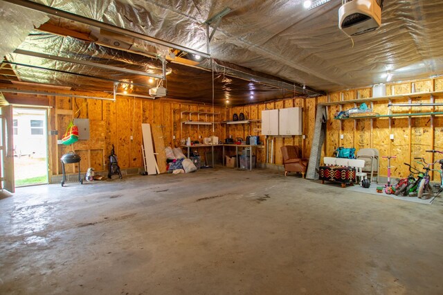 724 10th St NW, Bemidji, MN 56601 - garage featuring a garage door opener and a workshop area