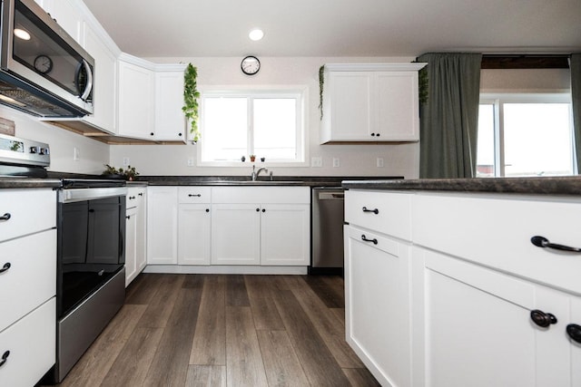 713 Prairie Wind Ave, Callaway, MN 56521 - kitchen with stainless steel appliances, recessed lighting, white cabinetry, dark wood-style floors, and dark countertops