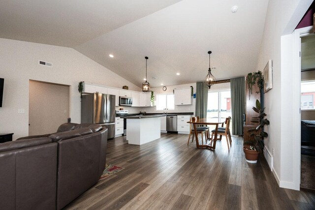 713 Prairie Wind Ave, Callaway, MN 56521 - living area with lofted ceiling, dark wood finished floors, and recessed lighting