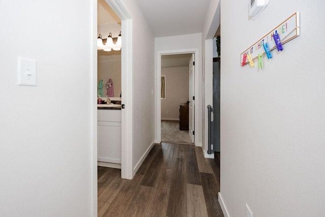 713 Prairie Wind Ave, Callaway, MN 56521 - corridor featuring dark wood-type flooring and baseboards