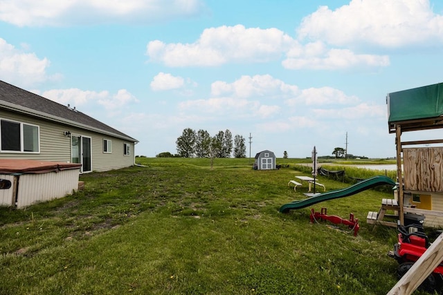 713 Prairie Wind Ave, Callaway, MN 56521 - view of green lawn with a storage shed and a playground