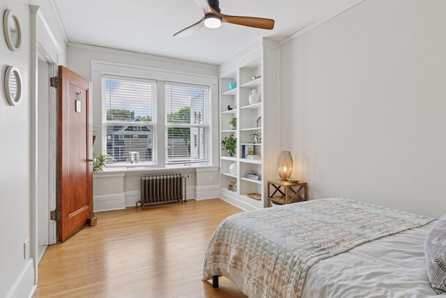 436 Holly Ave Unit 3, Saint Paul, MN 55102 - bedroom featuring radiator heating unit, wood finished floors, crown molding, and ceiling fan