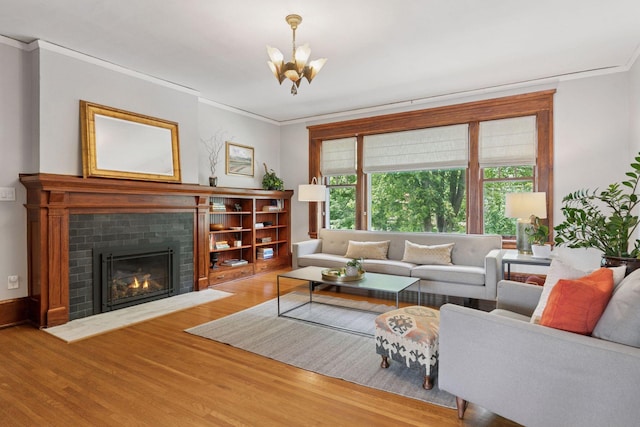 436 Holly Ave Unit 3, Saint Paul, MN 55102 - living area with ornamental molding, wood finished floors, a chandelier, and a brick fireplace