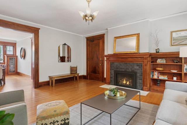 436 Holly Ave Unit 3, Saint Paul, MN 55102 - living room with crown molding, light wood-type flooring, a brick fireplace, and a chandelier