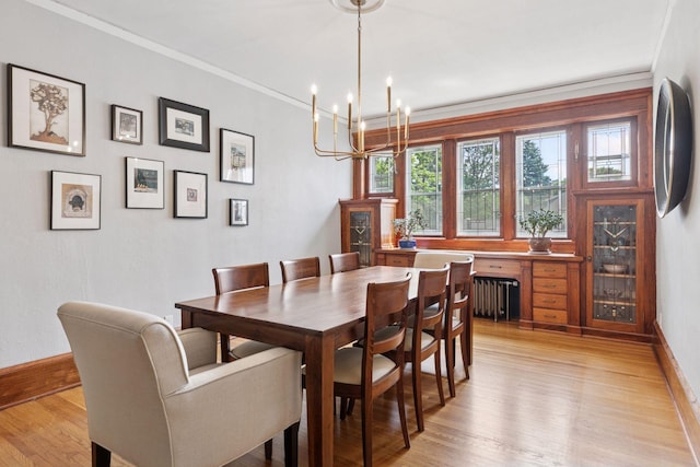 436 Holly Ave Unit 3, Saint Paul, MN 55102 - dining area with radiator, a chandelier, light wood-style flooring, and ornamental molding