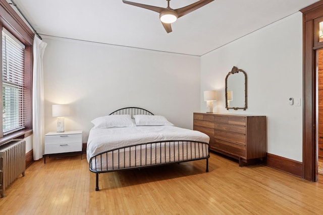 436 Holly Ave Unit 3, Saint Paul, MN 55102 - bedroom with radiator heating unit, light wood-style floors, and a ceiling fan