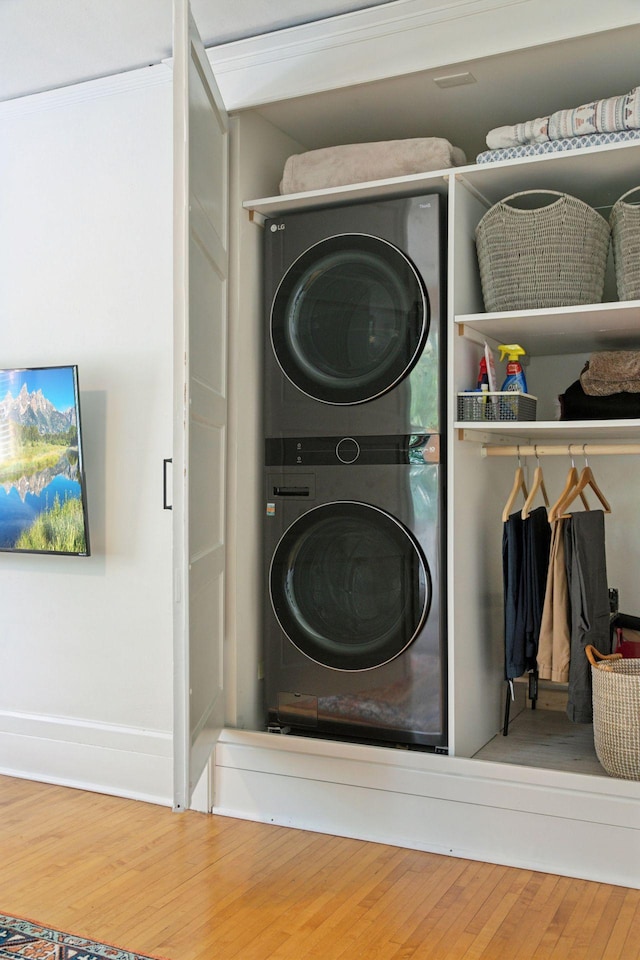 436 Holly Ave Unit 3, Saint Paul, MN 55102 - washroom with stacked washing machine and dryer and wood finished floors