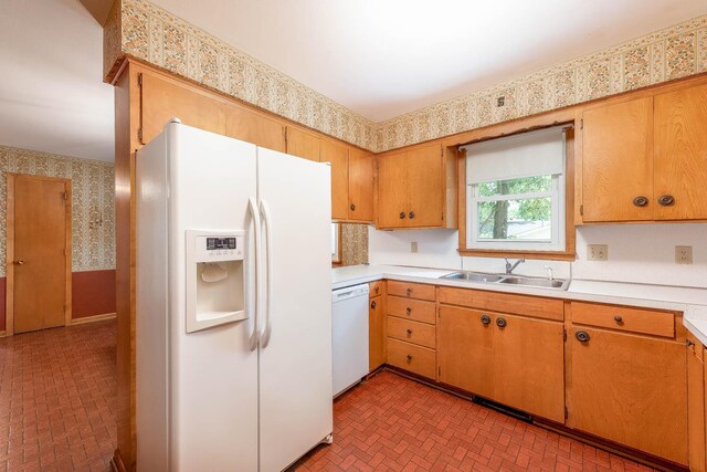 419 Jackson St, Saint Peter, MN 56082 - kitchen with white appliances, wallpapered walls, brick patterned flooring, and light countertops