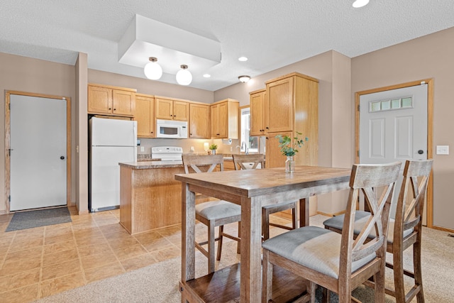 3010 Hazelwood St, Maplewood, MN 55109 - kitchen featuring white appliances, light brown cabinets, a textured ceiling, recessed lighting, and light countertops