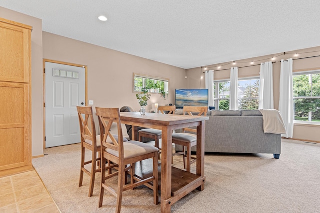3010 Hazelwood St, Maplewood, MN 55109 - dining space featuring a textured ceiling, light colored carpet, and recessed lighting