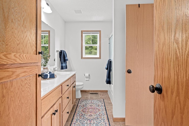 3010 Hazelwood St, Maplewood, MN 55109 - bathroom with double vanity, a shower, tile patterned flooring, and a textured ceiling
