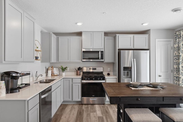 13636 Kaylemore Trl, Rosemount, MN 55068 - kitchen with stainless steel appliances, light wood-type flooring, a textured ceiling, light countertops, and recessed lighting