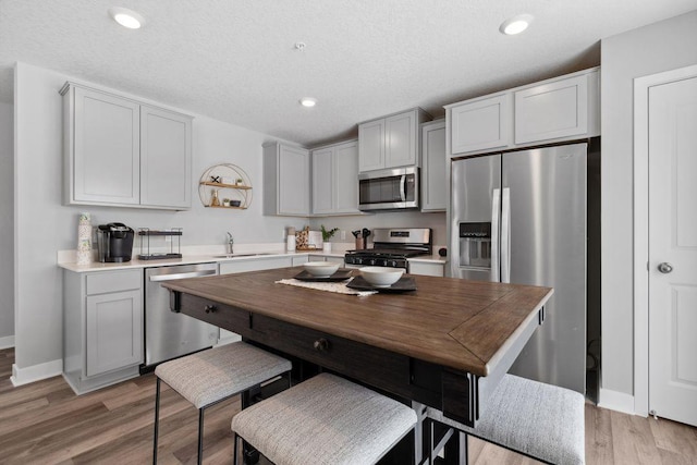 13636 Kaylemore Trl, Rosemount, MN 55068 - kitchen featuring stainless steel appliances, light wood-style flooring, light countertops, gray cabinets, and recessed lighting