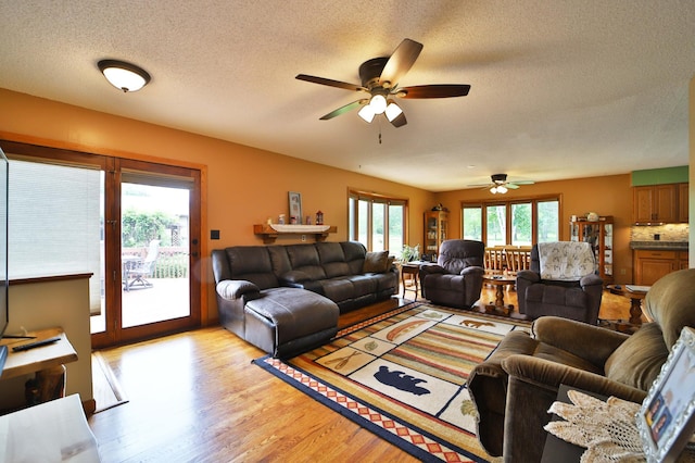 39808 340th Ln, Aitkin, MN 56431 - living room featuring ceiling fan, light wood finished floors, and a textured ceiling