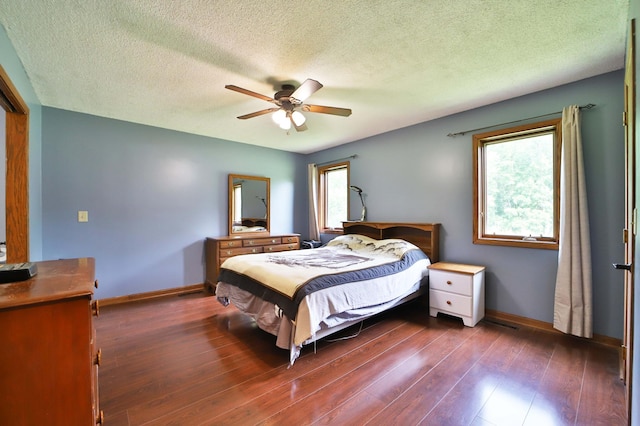 39808 340th Ln, Aitkin, MN 56431 - bedroom with dark wood-style floors, a ceiling fan, and a textured ceiling