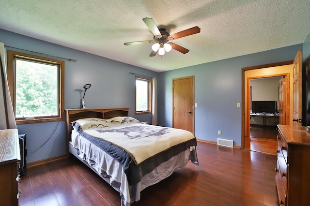 39808 340th Ln, Aitkin, MN 56431 - bedroom with dark wood finished floors, a textured ceiling, and ceiling fan