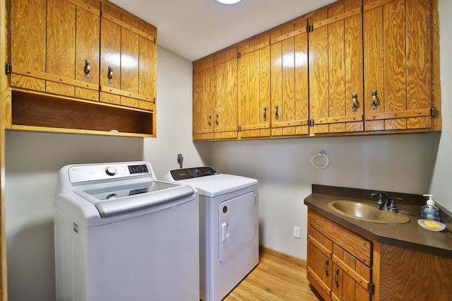 39808 340th Ln, Aitkin, MN 56431 - washroom with cabinet space, separate washer and dryer, and light wood-style floors