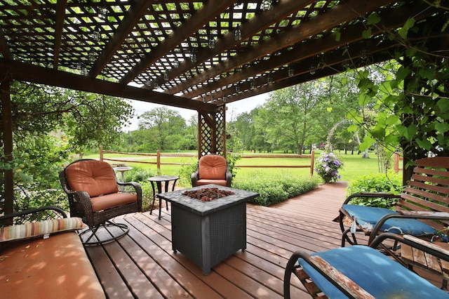 39808 340th Ln, Aitkin, MN 56431 - wooden deck featuring a pergola, a fire pit, view of wooded area, and a lawn