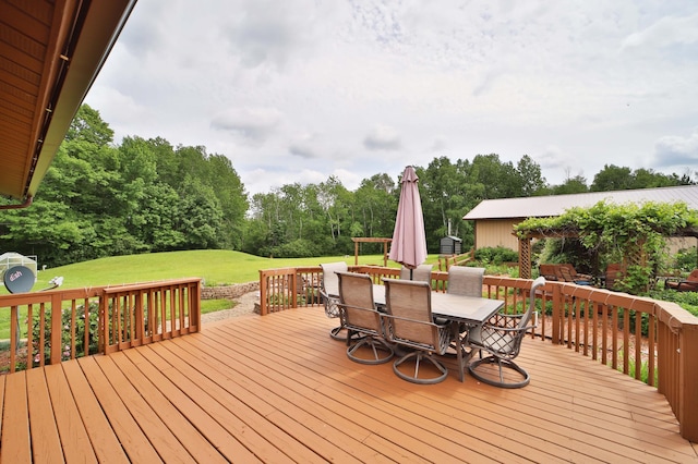 39808 340th Ln, Aitkin, MN 56431 - wooden deck featuring outdoor dining area, a yard, and view of wooded area