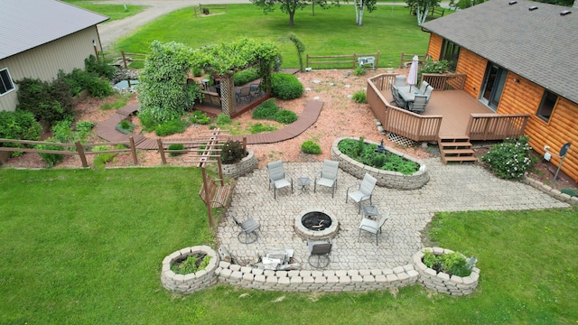 39808 340th Ln, Aitkin, MN 56431 - view of grassy yard with a fire pit, a wooden deck, and a patio area