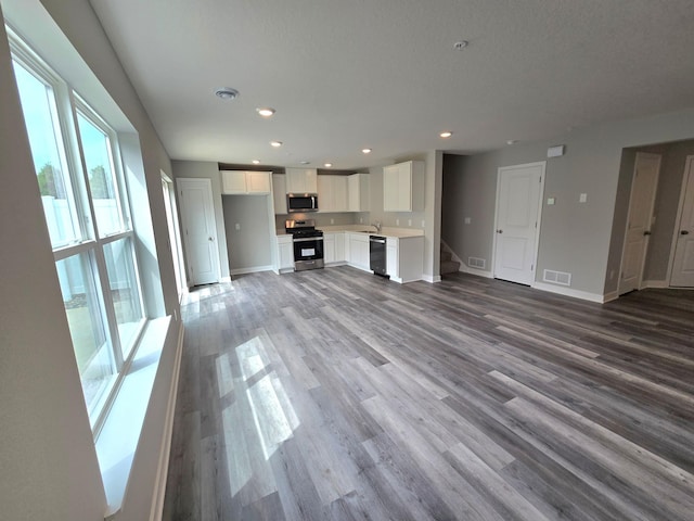 13643 Kaylemore Trl, Rosemount, MN 55068 - unfurnished living room with wood finished floors, recessed lighting, and stairs