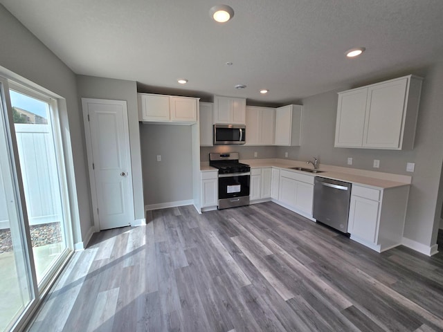13643 Kaylemore Trl, Rosemount, MN 55068 - kitchen featuring appliances with stainless steel finishes, white cabinets, light wood-style flooring, light countertops, and recessed lighting