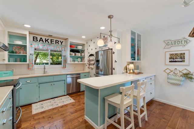 2068 Thorndale Ave, New Brighton, MN 55112 - kitchen with stainless steel appliances, open shelves, hardwood / wood-style floors, a peninsula, and light countertops