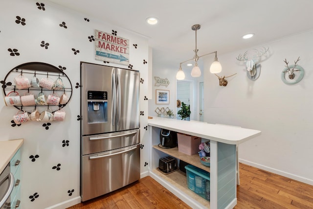 2068 Thorndale Ave, New Brighton, MN 55112 - kitchen featuring stainless steel refrigerator with ice dispenser, light wood-type flooring, a peninsula, light countertops, and recessed lighting