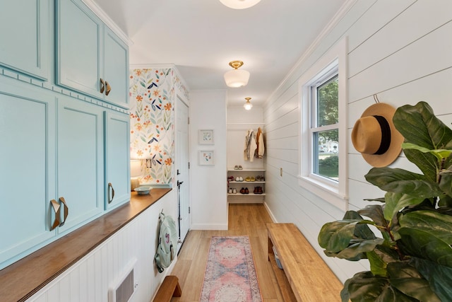 2068 Thorndale Ave, New Brighton, MN 55112 - hall with light wood-style flooring, ornamental molding, and wood walls