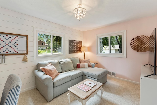 2068 Thorndale Ave, New Brighton, MN 55112 - carpeted living area with a chandelier and wood walls