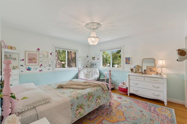 2068 Thorndale Ave, New Brighton, MN 55112 - bedroom with multiple windows, a chandelier, and wood finished floors