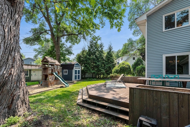 2068 Thorndale Ave, New Brighton, MN 55112 - wooden deck featuring a storage unit, a yard, and a playground