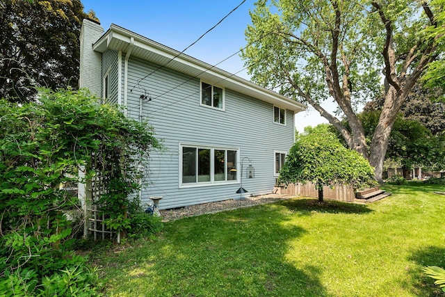2068 Thorndale Ave, New Brighton, MN 55112 - rear view of house with a chimney and a lawn